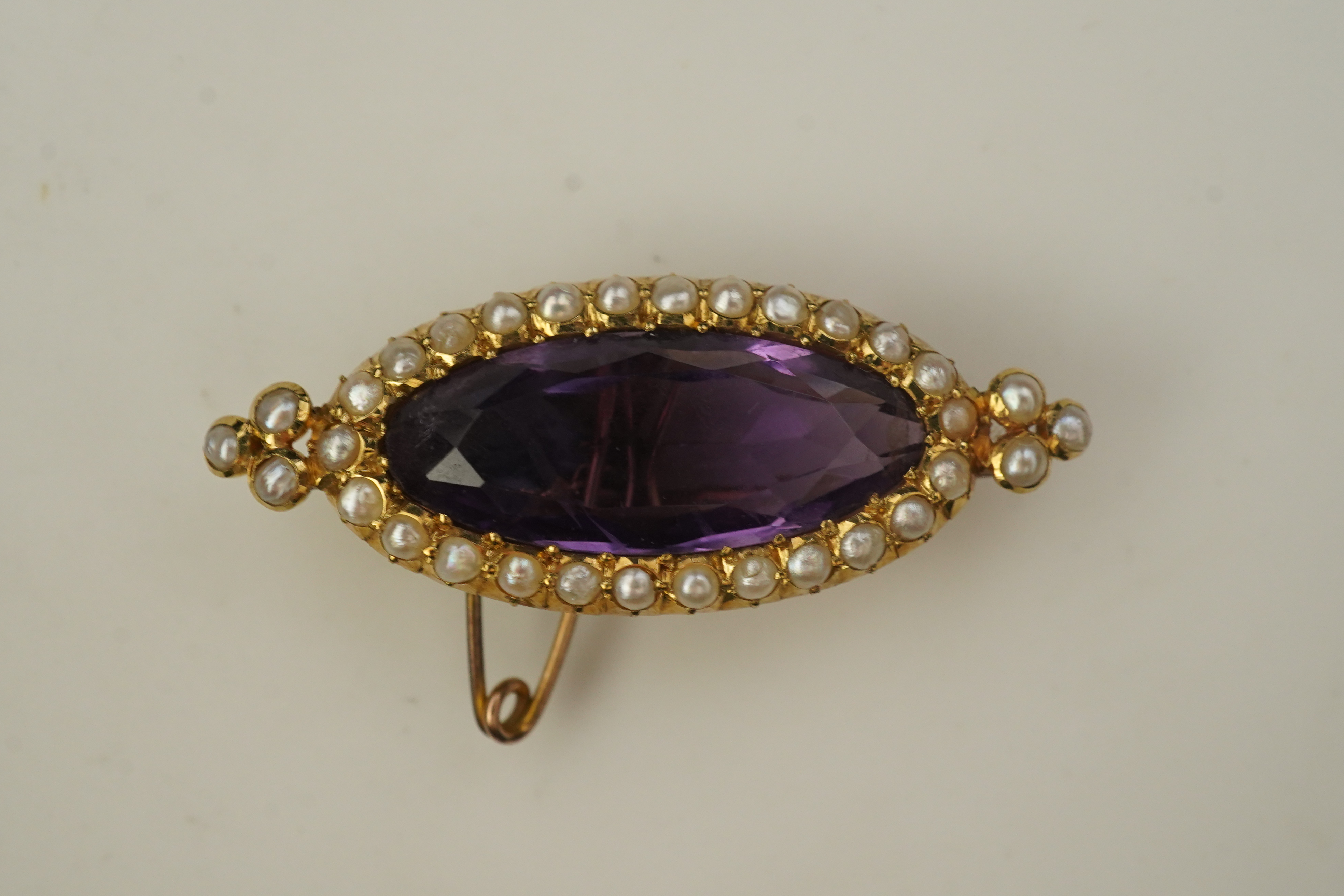 An amethyst and pearl brooch, circa 1900